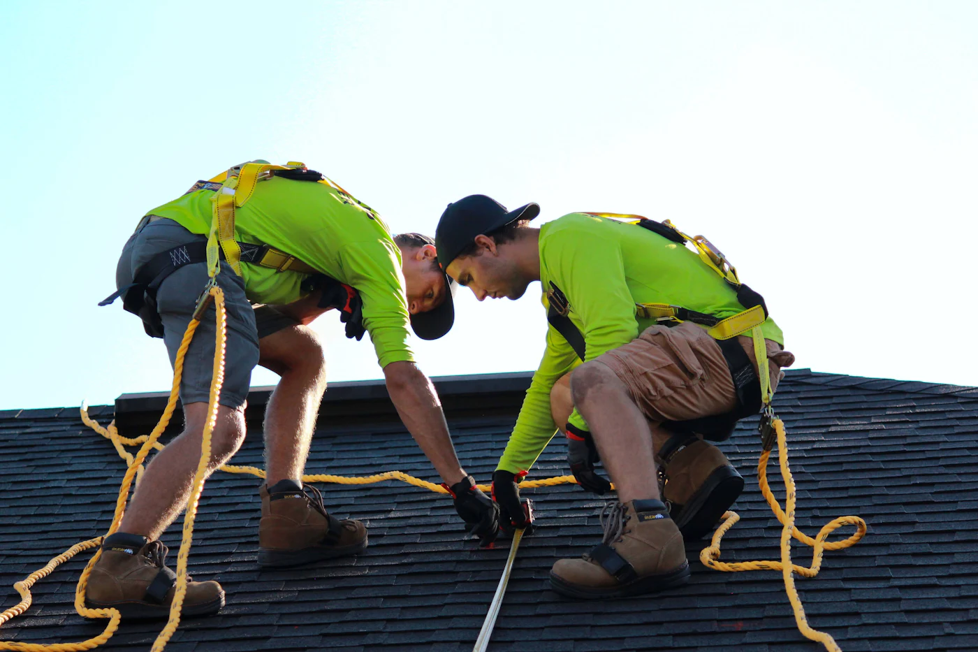 Two installers working on a roof